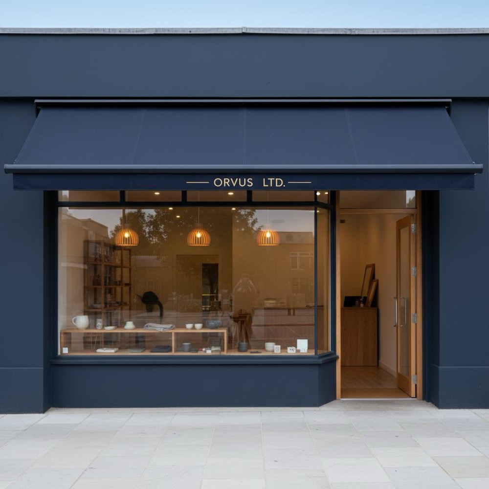 Daytime photo of tidy small retail storefront with warm interior lighting and space to optimize Google Business Profile; brand colors #0B1E33 and #C8A45D.